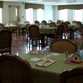 An empty dining room with neatly set tables and chairs.