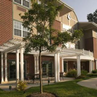 A residential building with a landscaped exterior and trees.