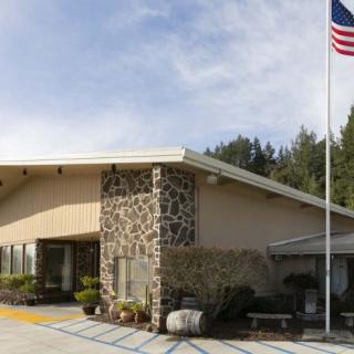 A building with a stone facade and an American flag flying outside.
