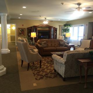 A cozy living room with comfortable seating and warm lighting.