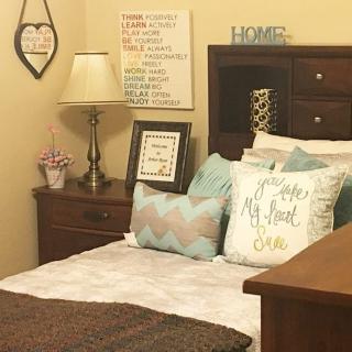 Cozy bedroom with decorative pillows and wall art