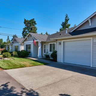 Suburban house with a driveway and garage on a sunny day.