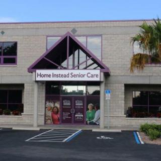 The exterior of a senior care facility with accessible parking spaces.