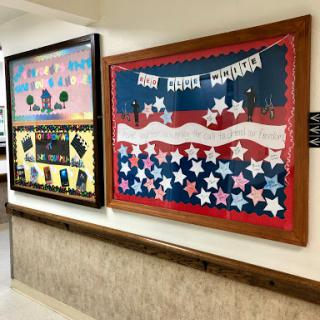 A vibrant display of patriotic art on a wall, featuring colorful stars and banners.