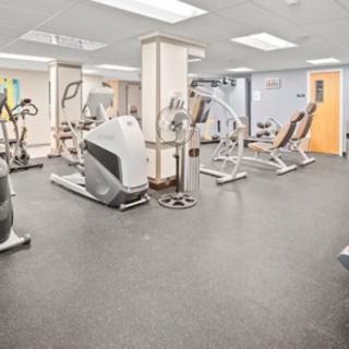 A spacious gym with a variety of fitness equipment and exercise machines.
