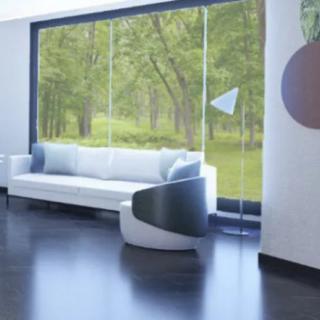 A modern living room with a minimalist design, featuring a white sofa and a large window overlooking nature.