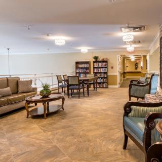 A cozy living room with comfortable seating and bookshelves.
