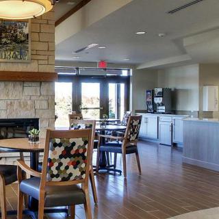 A cozy cafe interior with a fireplace and seating area.