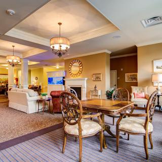 A cozy and contemporary living space featuring a dining area with elegant chandeliers.