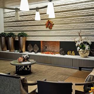 A modern living room with elegant decor, featuring a fireplace and contemporary lighting.