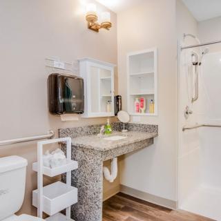 Modern bathroom with a vanity, mirror, and shower area.