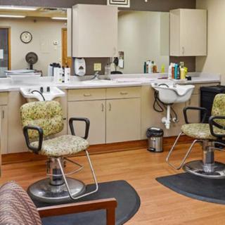 Interior view of a hair salon with chairs, mirrors, and sinks.