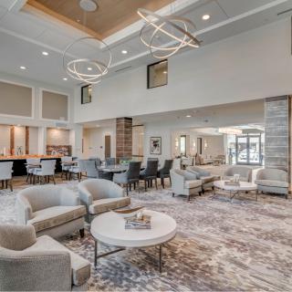 A luxurious and modern lobby featuring comfortable seating, elegant lighting fixtures, and stylish interior design.
