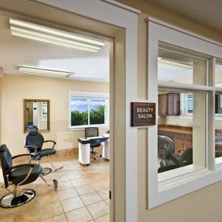 Interior view of a beauty salon with chairs and mirrors.