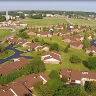 Aerial view of a peaceful suburban neighborhood with well-maintained homes and lush greenery.