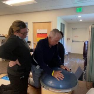 A person receiving guidance during a physical therapy session.