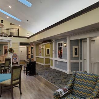 A bright and modern interior lobby featuring comfortable seating and vibrant colors.