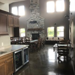A spacious and inviting kitchen and dining area featuring a stone fireplace and ample natural light.