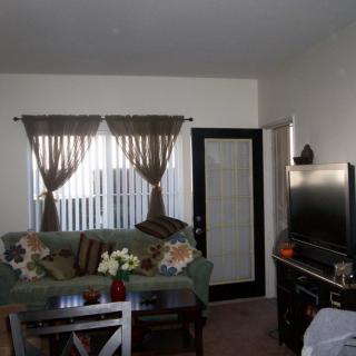 A cozy living room with a sofa, television, and decorative elements.