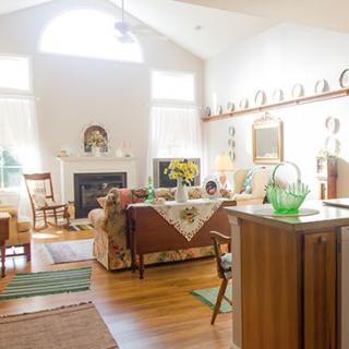 A cozy, bright living room with a fireplace and traditional decor.