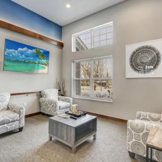 A modern living room with comfortable seating and decorative artwork.