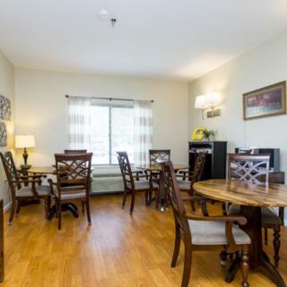 A cozy dining room with wooden furniture and natural lighting.