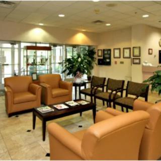 A comfortable waiting room with chairs and a reception area.