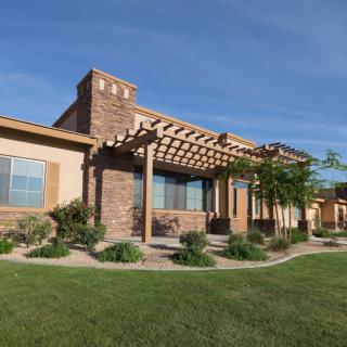 A modern house with a pergola and landscaped garden.