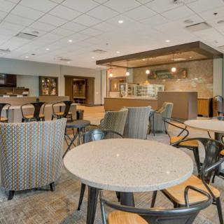 A modern cafeteria interior with tables and chairs, featuring a clean and spacious dining area.
