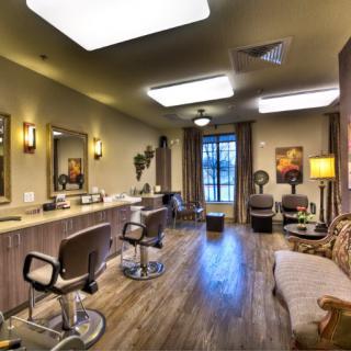A modern beauty salon interior with comfortable seating and stylish decor.