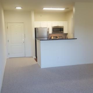 A modern apartment with an open kitchen and living area.