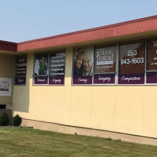 A clinic building with advertisements and contact information displayed on the windows.