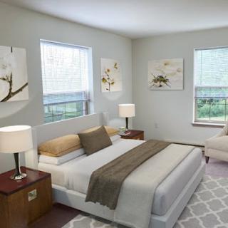 A beautifully designed modern bedroom featuring a comfortable bed, stylish furniture, and soft natural light.