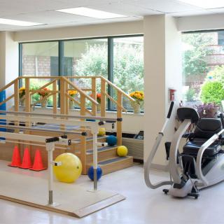 A rehabilitation center equipped with various exercise machines and tools for physical therapy.