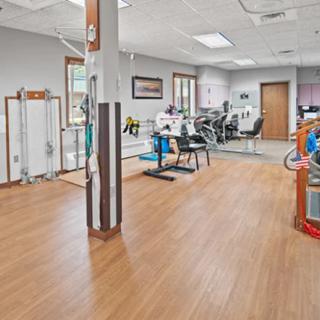 Spacious gym area with various fitness equipment and exercise machines.
