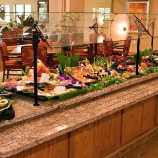 A restaurant buffet with a variety of food options displayed.
