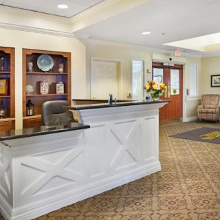 A welcoming lobby with a reception desk and seating area.
