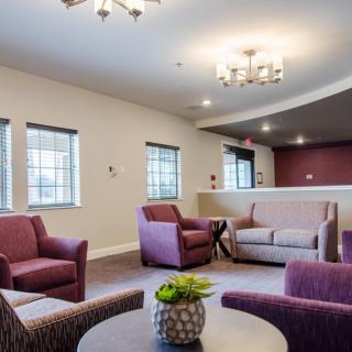 A modern living room with comfortable seating and decorative lighting.