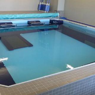 An indoor therapy pool designed for aquatic rehabilitation and exercise.
