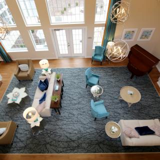 A modern living room with elegant furniture and large windows.