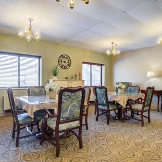 A warmly lit dining room with traditional furniture and elegant decor.