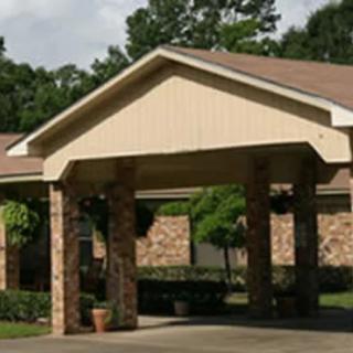 A covered entrance with brick pillars and a peaked roof.