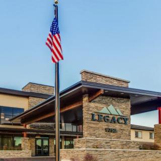 The entrance to a building with stone architecture and an American flag.