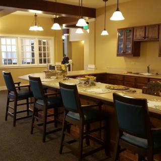 A cozy kitchen interior with a high counter and bar stools.