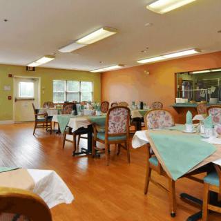 An inviting dining room with neatly arranged tables and chairs, set in a warmly decorated interior.