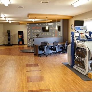 A modern gym facility with various exercise equipment and a spacious layout.