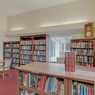 A cozy library room with bookshelves filled with a variety of books.