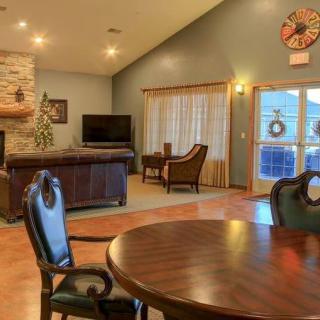 A cozy living room with modern decor featuring a fireplace, television, and comfortable seating.