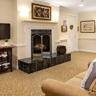 A cozy living room with a fireplace, television, and comfortable seating.