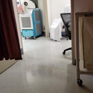 A glimpse into a hospital room showing the floor and some medical equipment.
